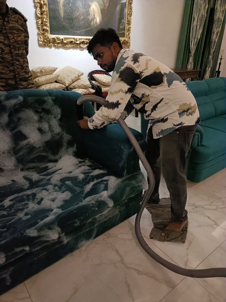 Teal sofa being foam-cleaned by Perfect Cleaner